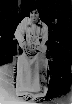 Sai as boy, sitting in a wooden chair