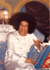 Seated, in white robe